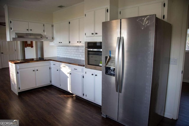 kitchen featuring white cabinets, decorative backsplash, dark wood-type flooring, and appliances with stainless steel finishes