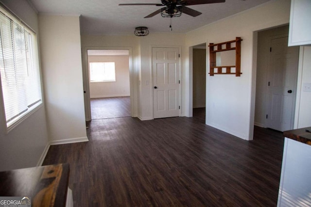 unfurnished room featuring a textured ceiling, ceiling fan, and dark hardwood / wood-style floors