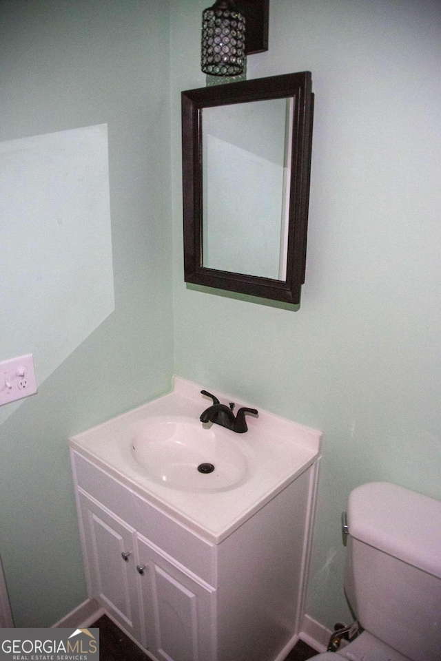 bathroom featuring vanity and toilet