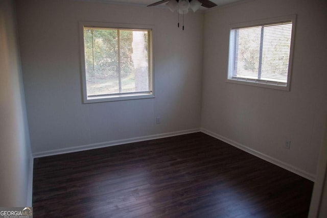 empty room featuring ceiling fan and dark wood-type flooring