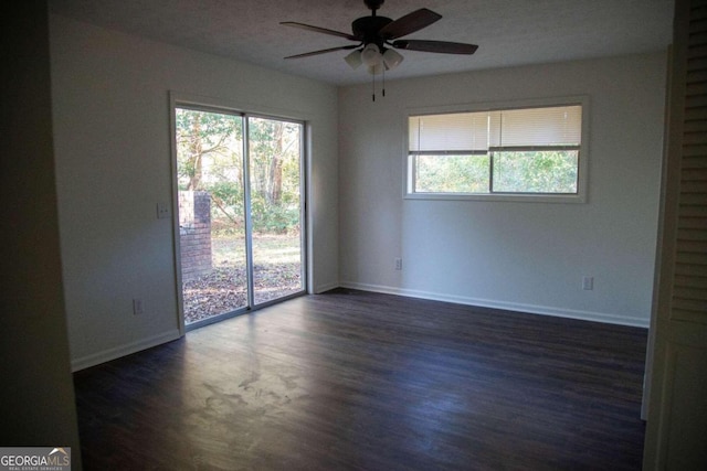 unfurnished room featuring dark hardwood / wood-style floors and ceiling fan