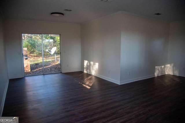 unfurnished room featuring dark hardwood / wood-style floors and ornamental molding