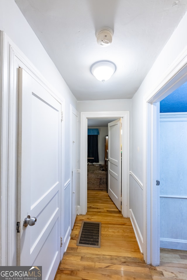 hallway with light wood-type flooring