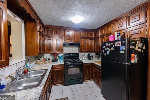 kitchen with backsplash, sink, black appliances, and a textured ceiling