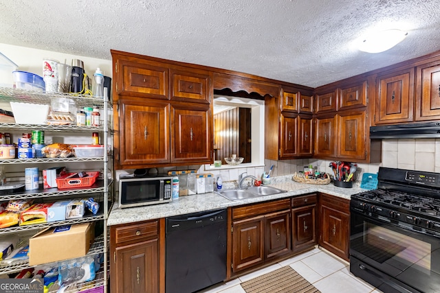 kitchen featuring backsplash, black appliances, sink, a textured ceiling, and light tile patterned flooring