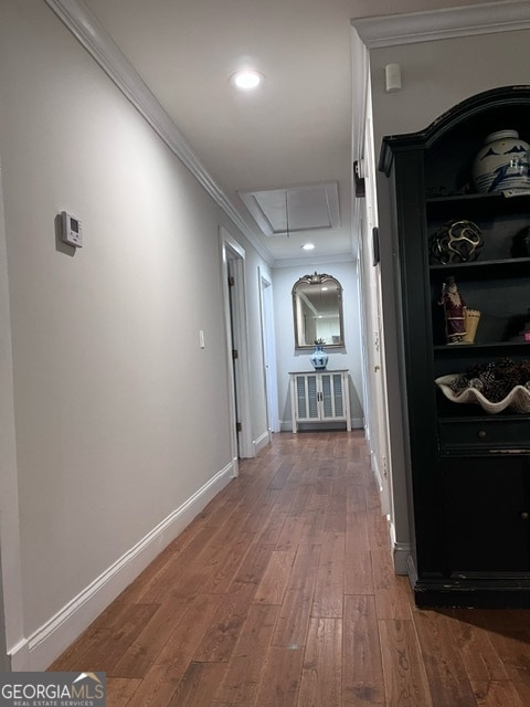 corridor featuring crown molding and hardwood / wood-style flooring