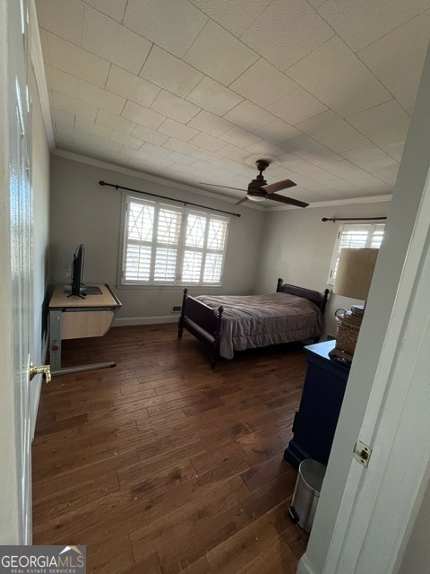 bedroom featuring multiple windows, ceiling fan, and dark wood-type flooring