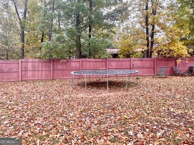 view of yard with a trampoline