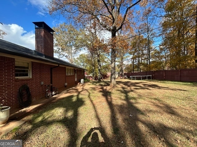 view of yard with a trampoline