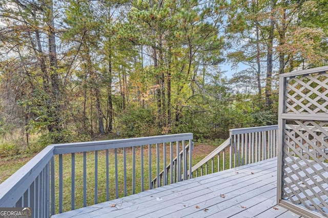 wooden deck featuring a yard