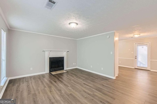 unfurnished living room featuring crown molding, hardwood / wood-style floors, and a textured ceiling