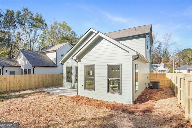 rear view of house featuring a patio area and central air condition unit