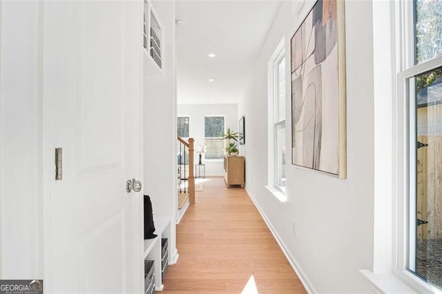 hallway with light hardwood / wood-style flooring