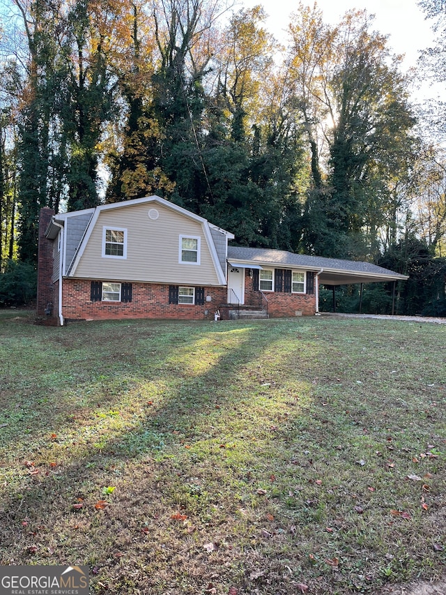 tri-level home with a carport and a front lawn