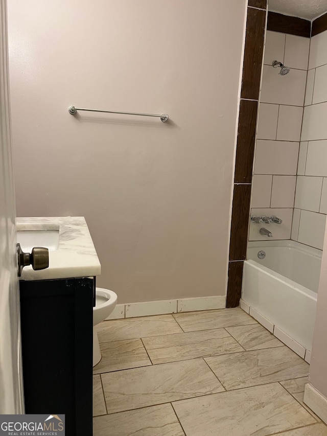 full bathroom with vanity, tiled shower / bath combo, and toilet