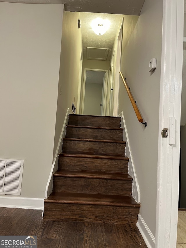 stairs featuring hardwood / wood-style flooring