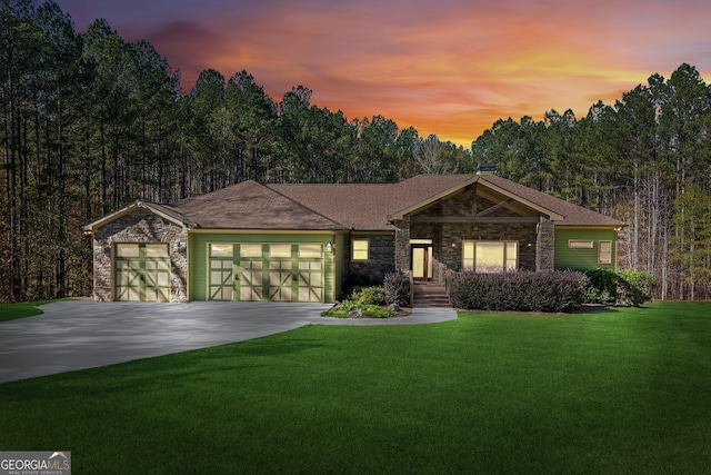 view of front of property featuring a garage and a yard