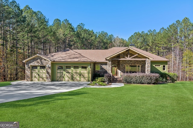 view of front of home with a garage and a front lawn