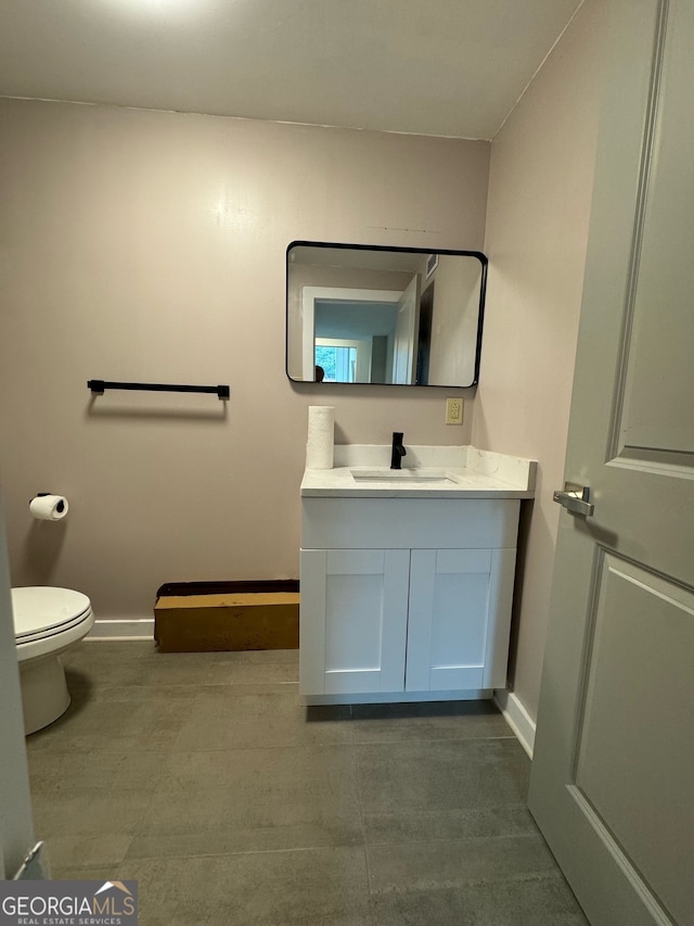 bathroom featuring vanity and toilet