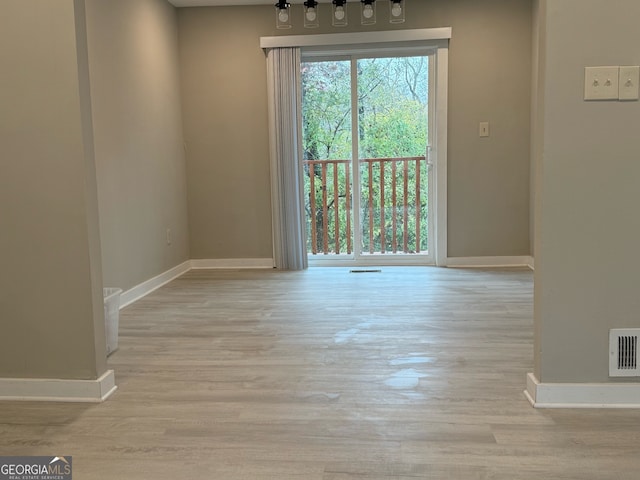 unfurnished room with light hardwood / wood-style flooring