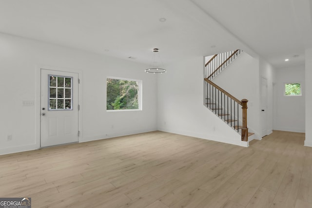 unfurnished living room with light wood-type flooring