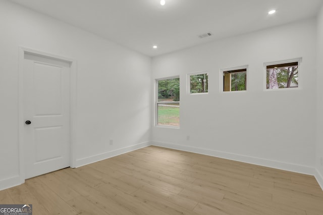 empty room with light hardwood / wood-style flooring