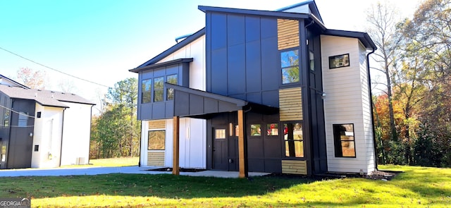 rear view of property featuring a lawn