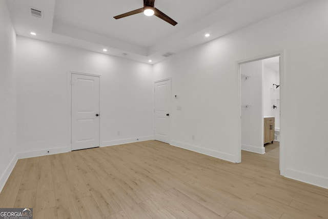 spare room featuring a healthy amount of sunlight and light hardwood / wood-style floors