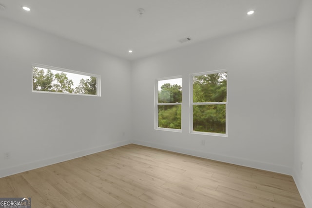 spare room featuring light hardwood / wood-style floors