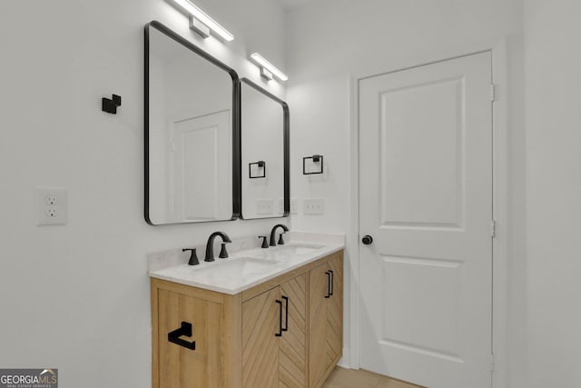 bathroom featuring tile patterned flooring and vanity