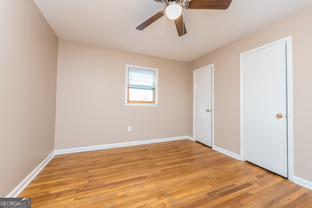 unfurnished bedroom featuring ceiling fan and light wood-type flooring