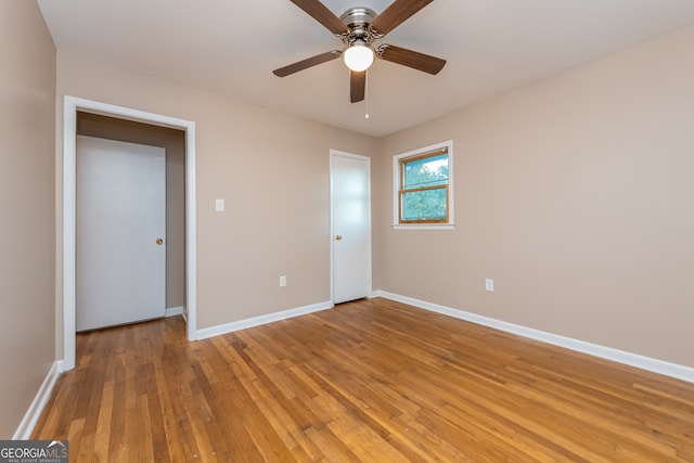 unfurnished bedroom with ceiling fan and light wood-type flooring