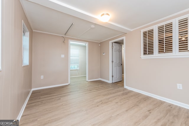 spare room with light hardwood / wood-style flooring and ornamental molding