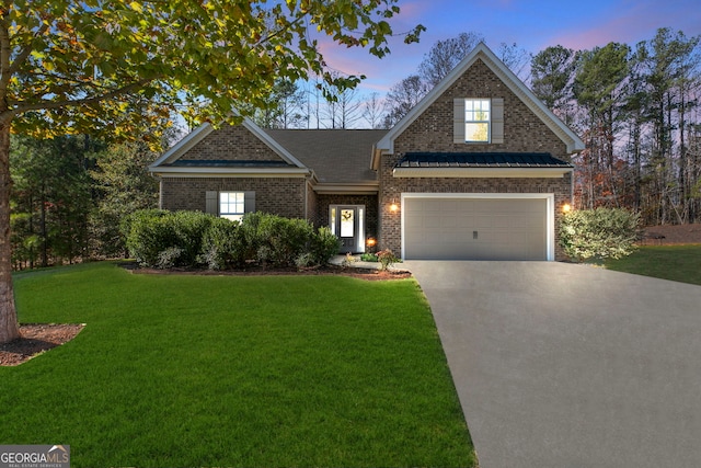 view of front facade with a garage and a yard