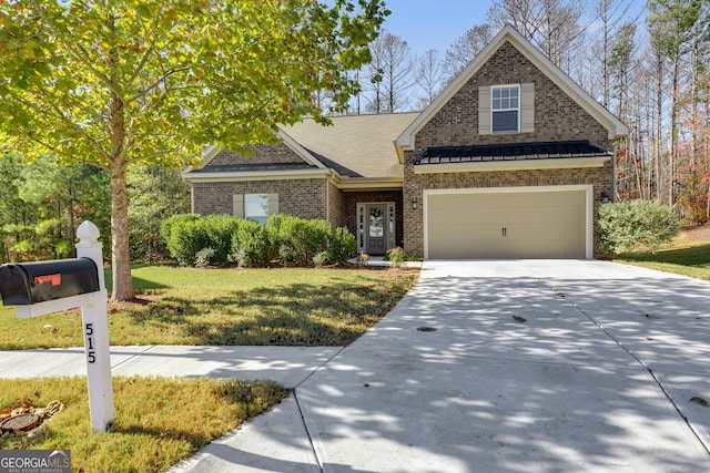 view of front of house featuring a garage and a front lawn