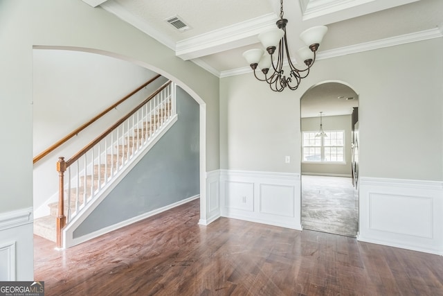 unfurnished dining area with a chandelier, hardwood / wood-style floors, and crown molding