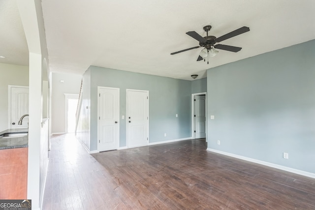 interior space featuring ceiling fan, dark wood-type flooring, and sink