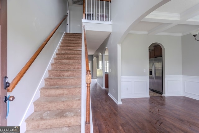 staircase with hardwood / wood-style floors, ornamental molding, beamed ceiling, and coffered ceiling