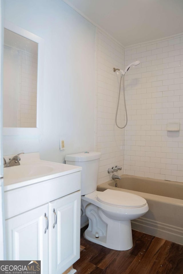 full bathroom with vanity, toilet, wood-type flooring, and tiled shower / bath