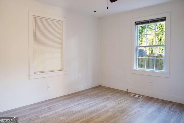 empty room with light hardwood / wood-style floors and ceiling fan