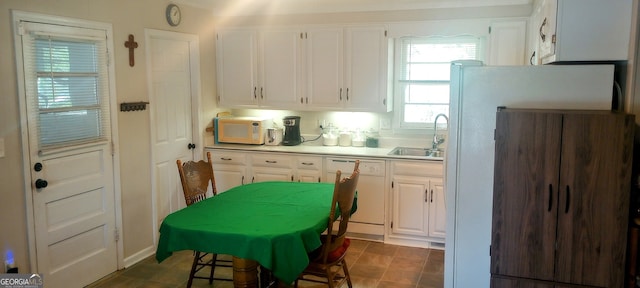 kitchen with sink, white cabinets, and white appliances