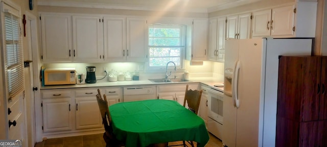 kitchen featuring white cabinets, white appliances, and sink