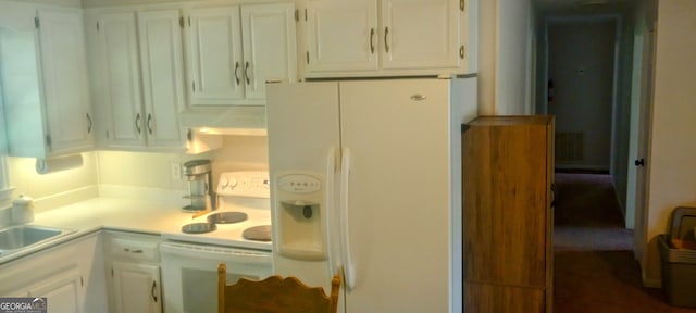 kitchen featuring white cabinets and white appliances