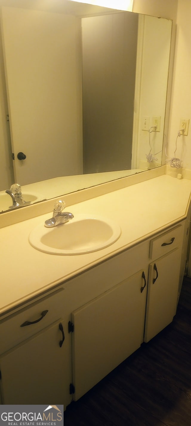 bathroom with hardwood / wood-style floors and vanity