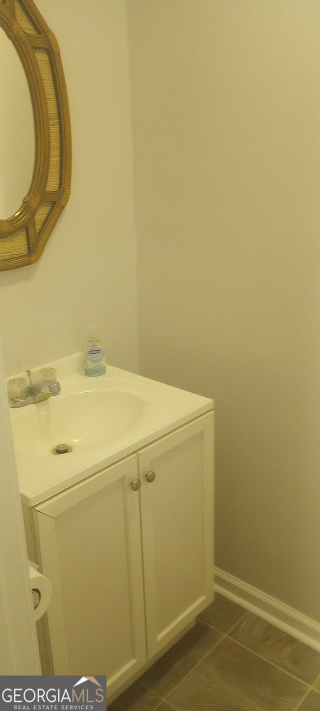 bathroom featuring tile patterned flooring and vanity