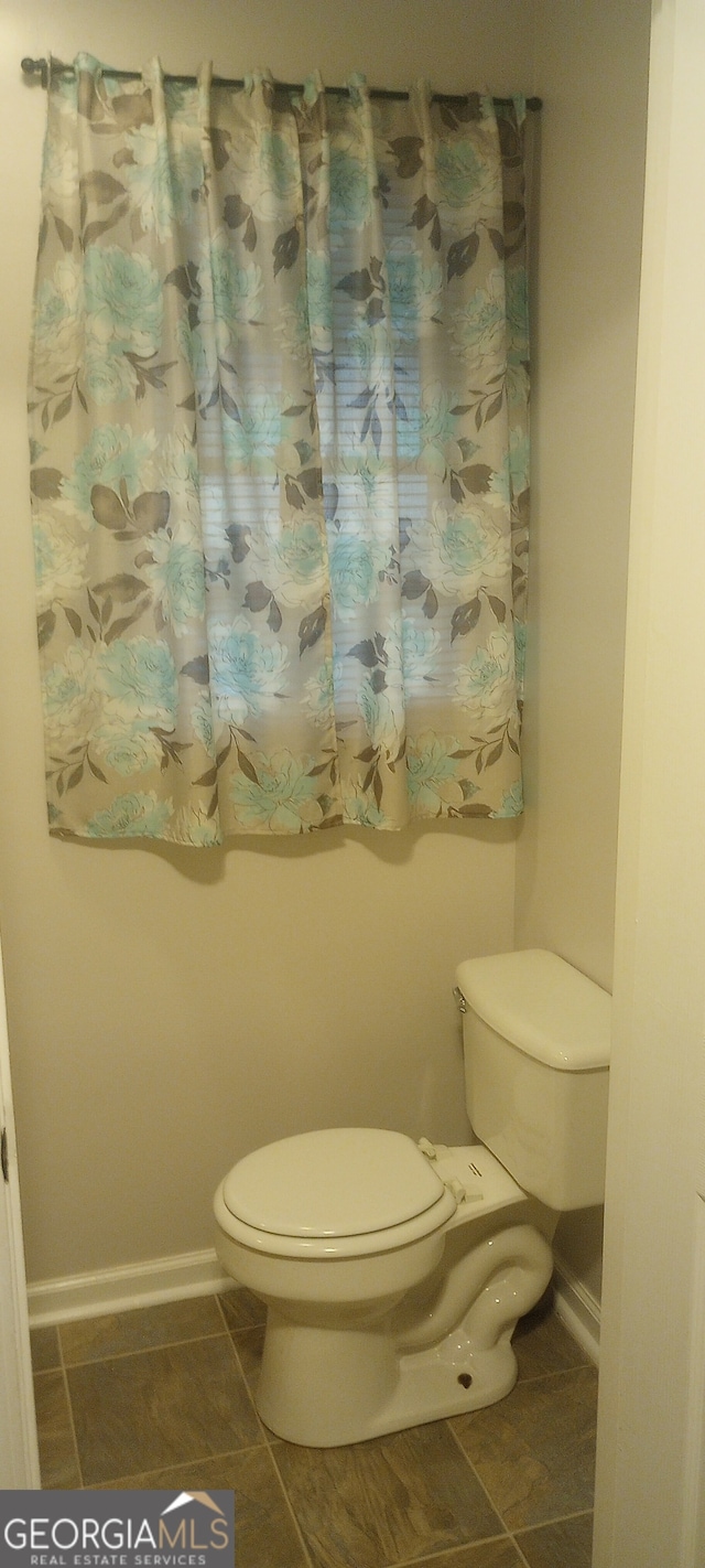 bathroom featuring tile patterned flooring and toilet