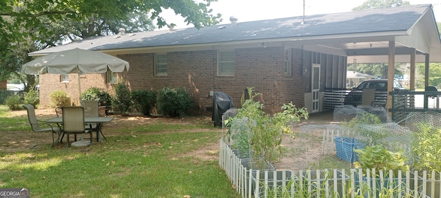 rear view of property with a yard