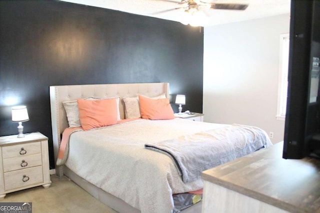 bedroom with ceiling fan and light colored carpet