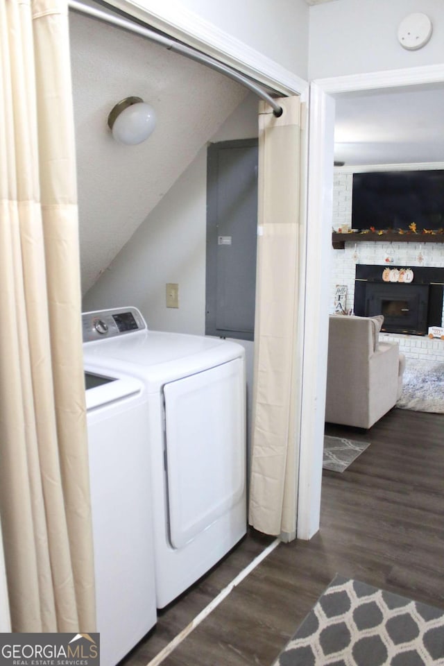 laundry area with a fireplace, separate washer and dryer, and dark hardwood / wood-style floors