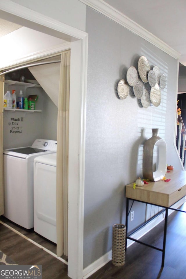 washroom featuring independent washer and dryer, dark wood-type flooring, and ornamental molding